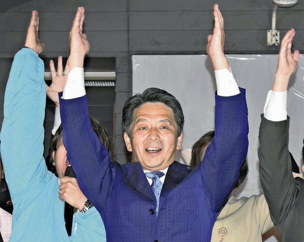 再選を決めて万歳をする谷島氏（２１日午後９時５分、石岡市で）