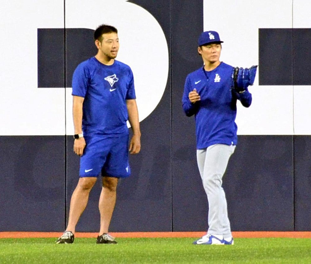 試合前、ブルージェイズの菊池雄星（左）にあいさつし、言葉を交わしたドジャースの山本由伸（４月２８日、カナダ・トロントのロジャースセンターで）＝帯津智昭撮影