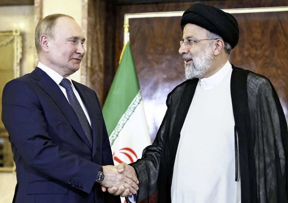 テヘランでロシアのプーチン大統領（左）と握手するライシ大統領（２０２２年７月）＝ＡＰ