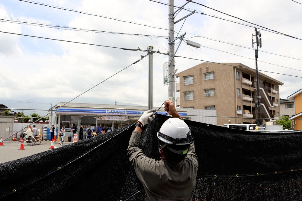 富士山とコンビニ店を見えなくする幕を設置する工事が進められた（２１日、山梨県富士河口湖町で）＝木村誠撮影