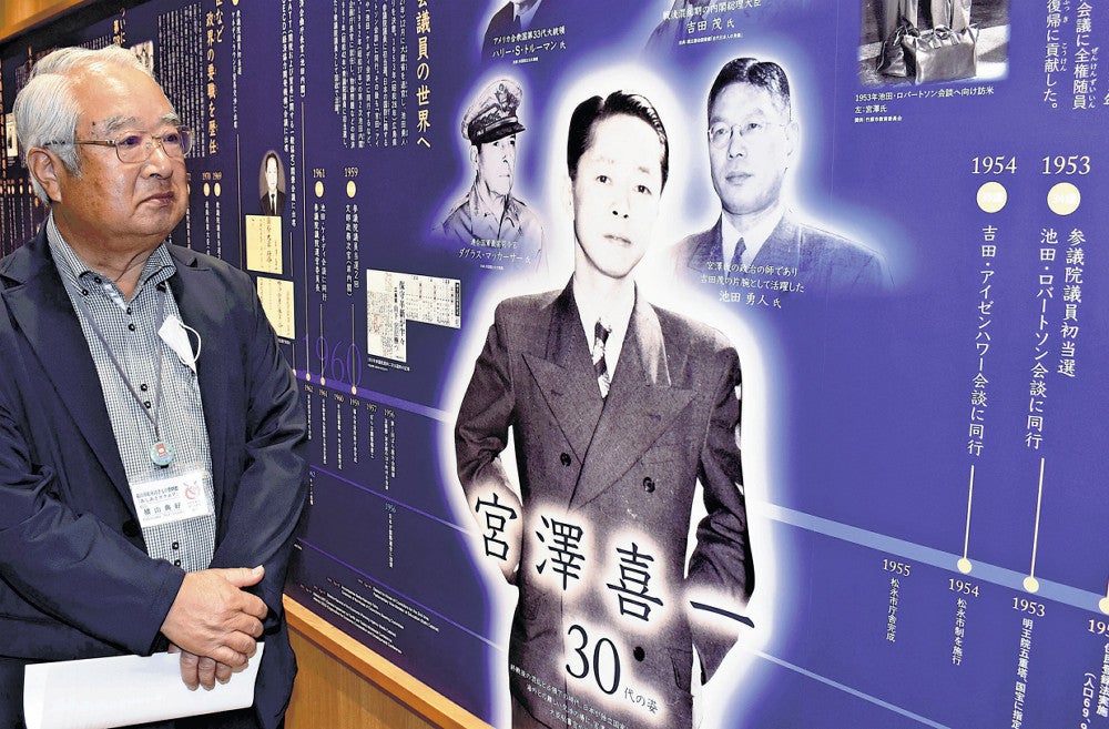 展示物を感慨深げに見つめる横山さん（広島県福山市で）