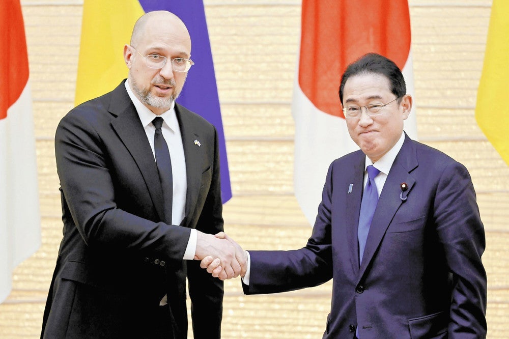 ウクライナのシュミハリ首相（左）と握手する岸田首相（２月１９日）＝黒瀬祐生撮影