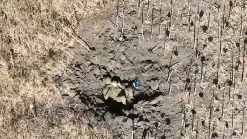 クレーターに横たわるロシア兵士が、爆発に失敗したFPVドローンの標的となりショックを受ける。