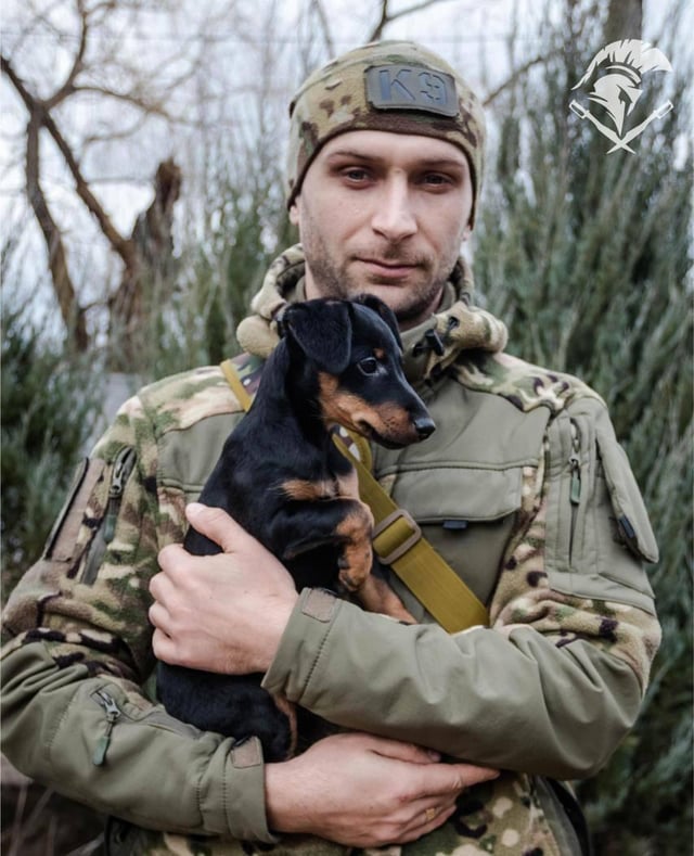 ウクライナ国家警備隊の第18スロビャンスク旅団所属のウクライナ人兵士とその犬。