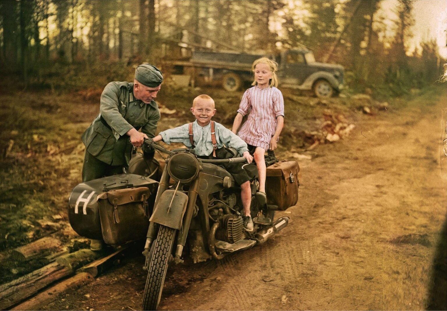 継続戦争中にスオムサルミのレイテロードでBMW R12オートバイとサイドカーに2人のフィンランド人の子供を持つドイツの兵士