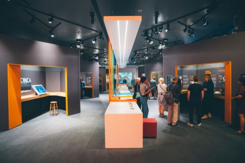 部屋の中央、移民の歴史をたどる年表のテーブルをはさみ、左の壁には歓迎された移民、右には拒まれたり虐げられたりした移民の歴史が展示されている。 Photo: Destination Canada/Benjamin Johnson