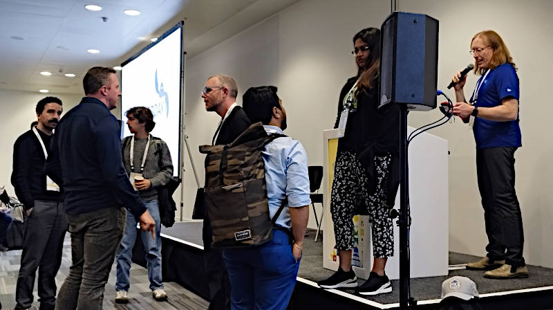 壇上の女性がDalby氏、中央で左を向いている眼鏡の男性がMcMenemy氏