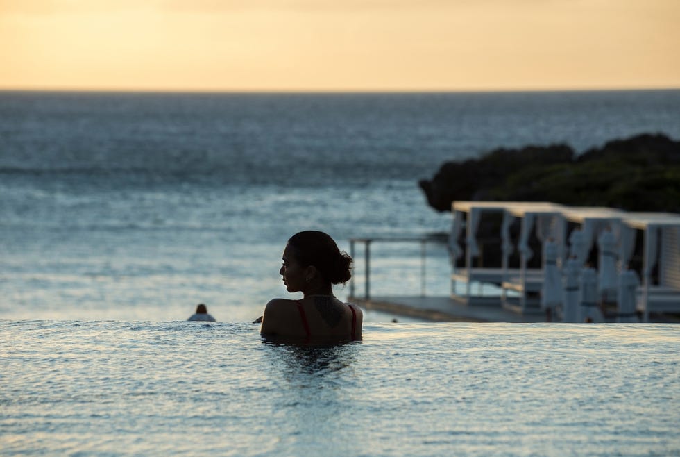 relaxation by the pool with ocean view at sunset