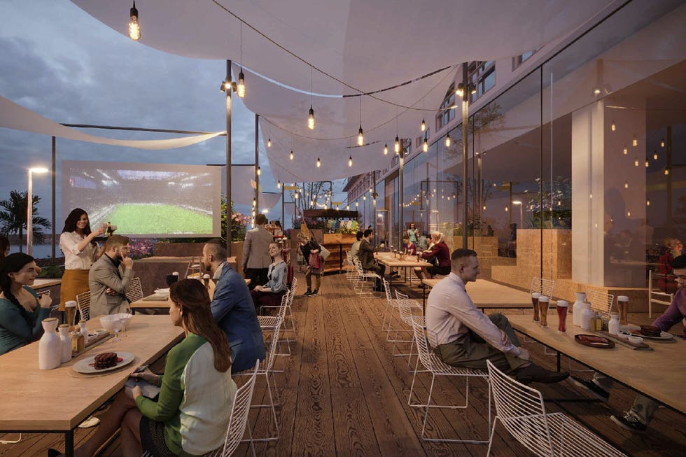 outdoor dining area with a large screen displaying a sports event