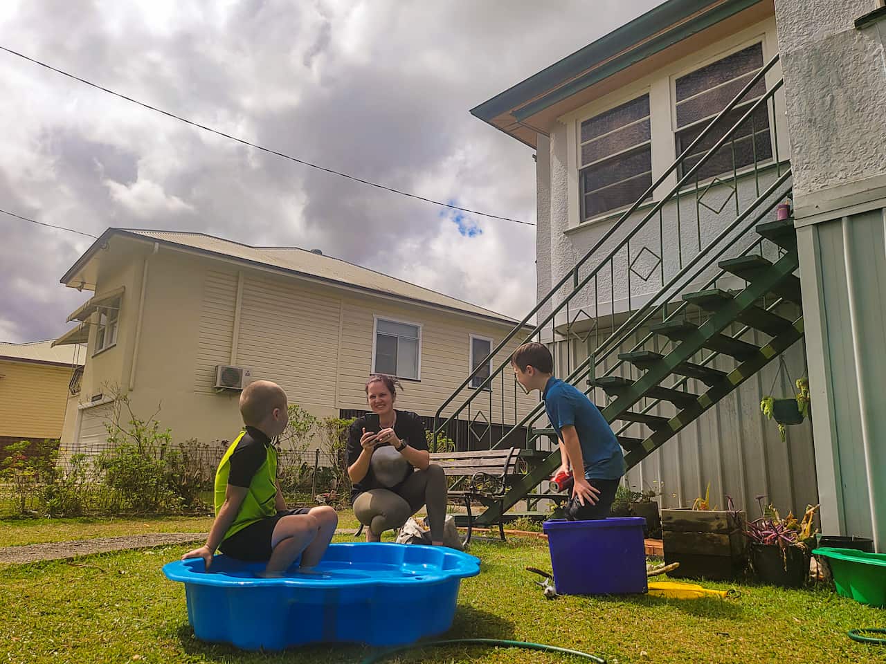 Boys Playing a Wading Pool in the Front Yard