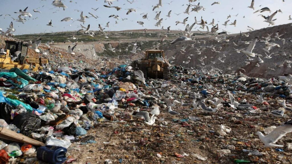 Earthmovers push mountains of garbage as seagulls fly over the country's largest landfill at Fyli on the outskirts of Athens in Greece.