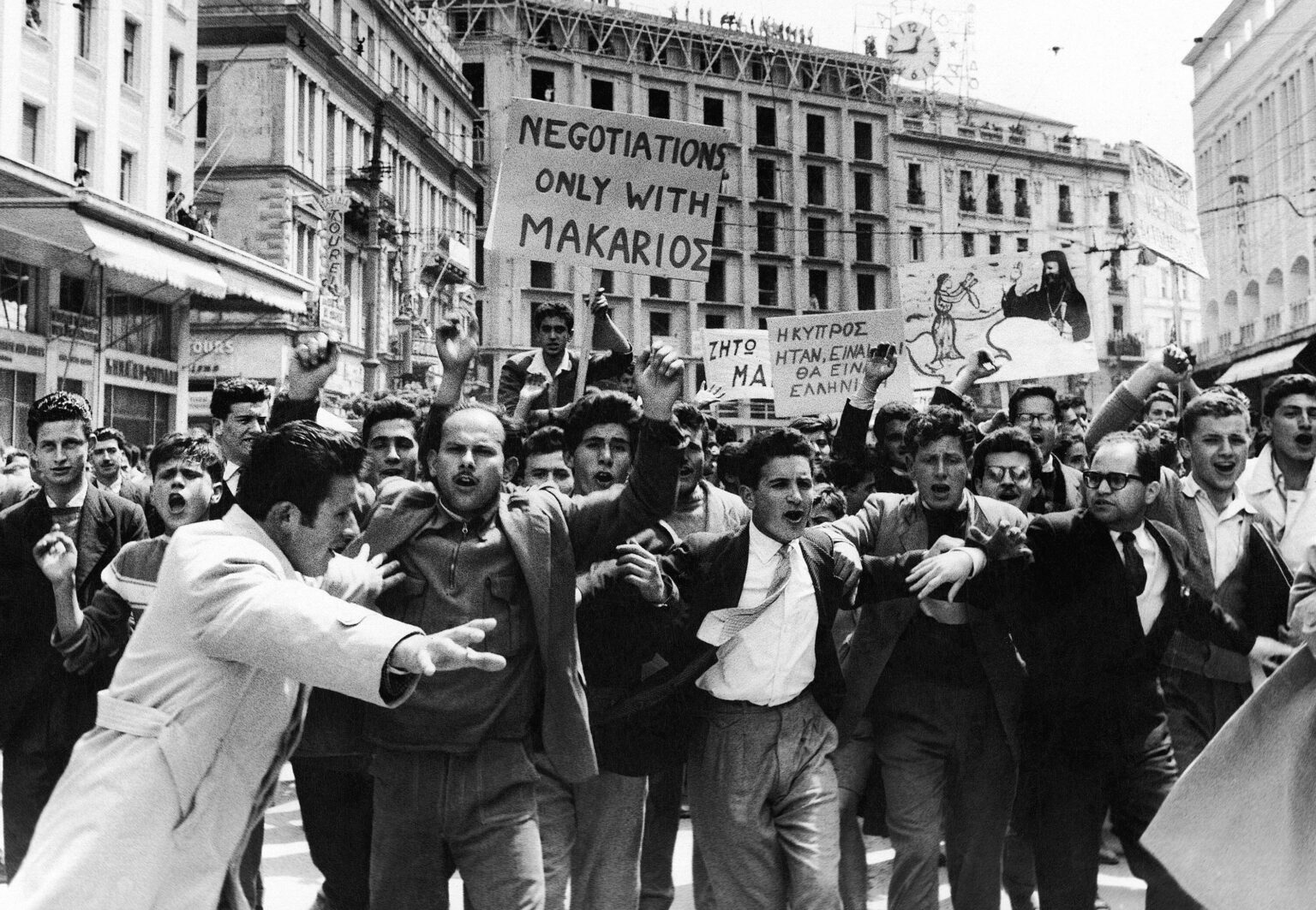 アテネで、キプロス独立運動の主導者であるマカリオス大司教がEOKA反乱を支援した疑いで英国亡命から最近帰国し、滞在していたホテル近くでデモを行うキプロス独立支持のギリシャ人学生たち。 (1957) [3000×2077]