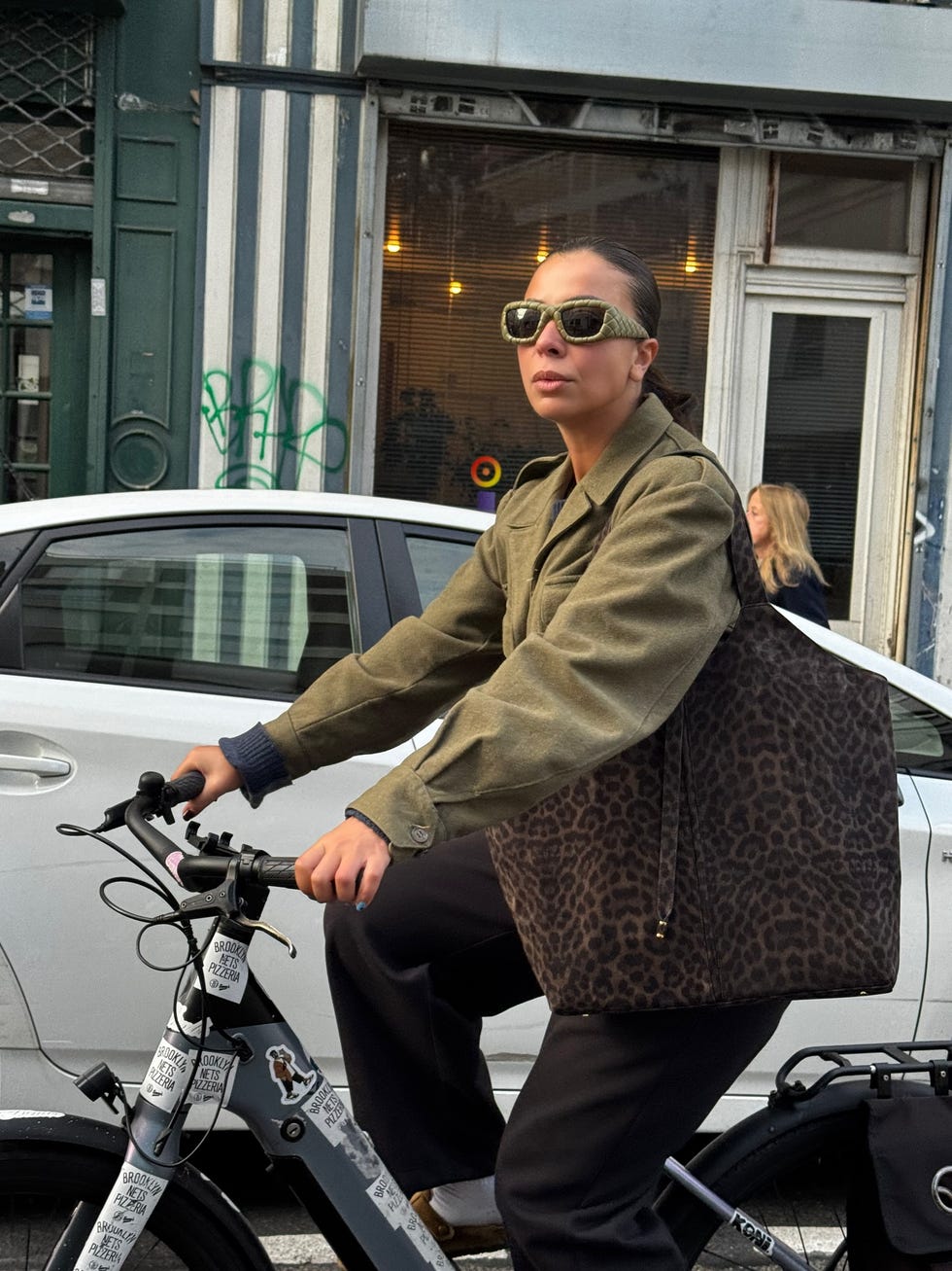 person riding a bicycle with a leopard print bag