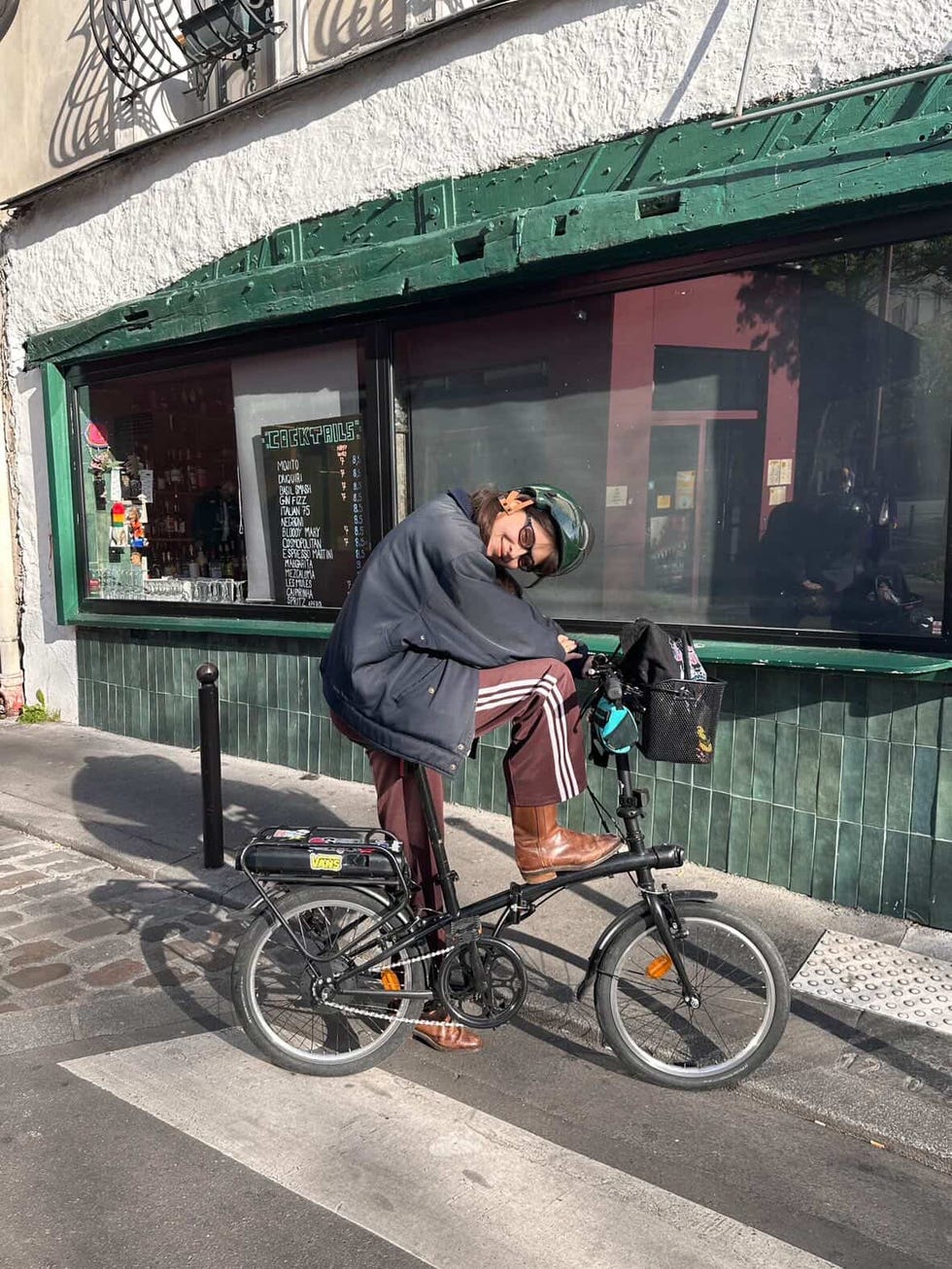 a person is perched on a bicycle positioned on a city street