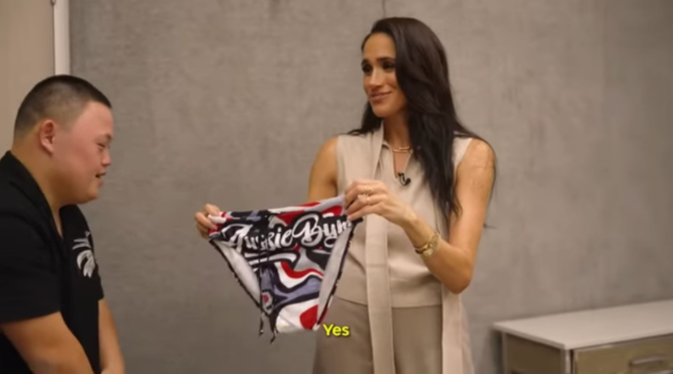 a woman holding swimwear while engaged in conversation