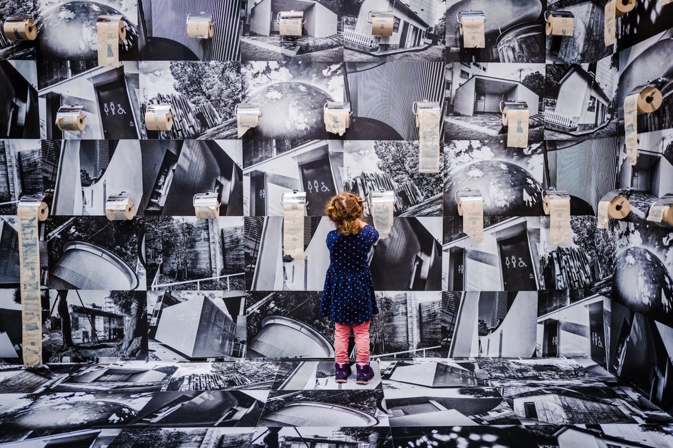 child interacting with a wall of patterned images
