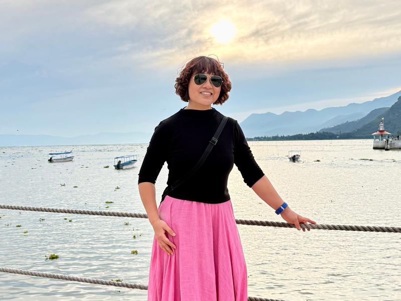 Woman posing next to water