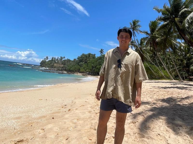 A man walking on a beach in Japan.