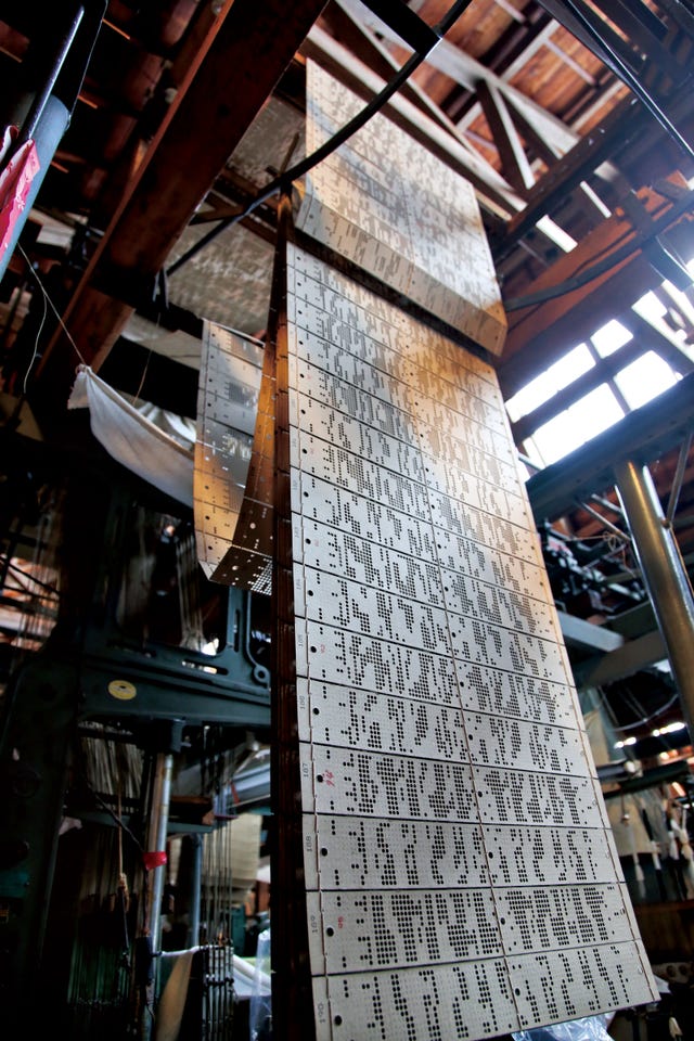 punched cards suspended in a workshop environment