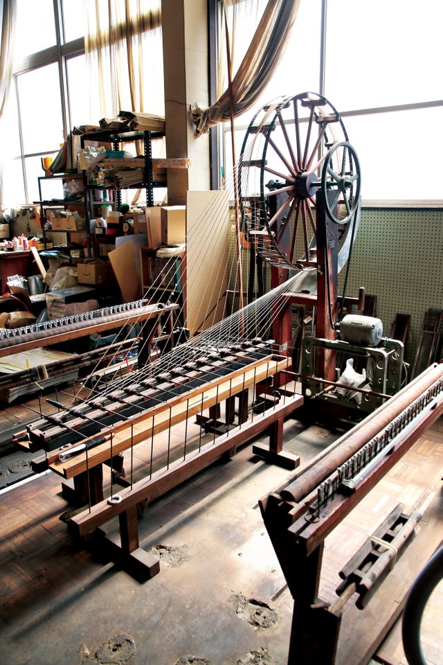 historic weaving equipment in a workshop setting