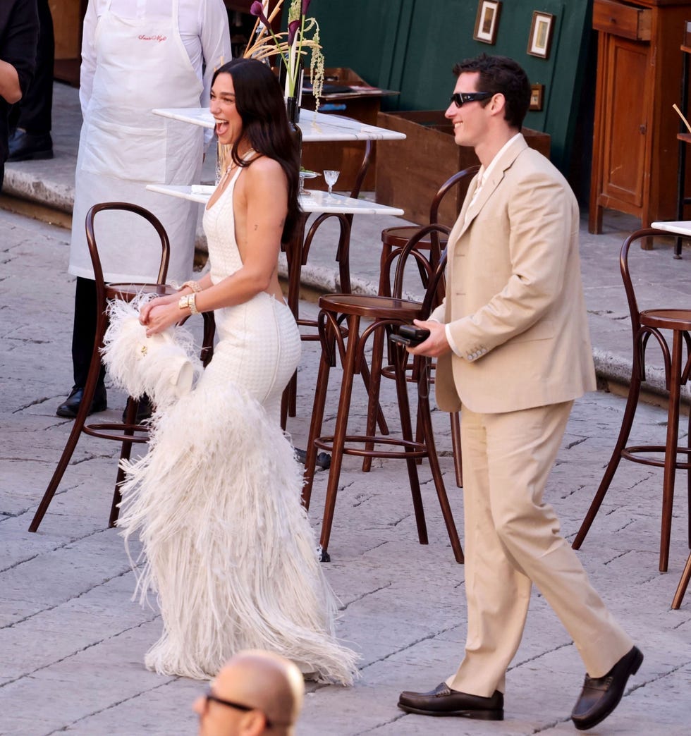 couple walking in an outdoor setting showcasing fashion and elegance
