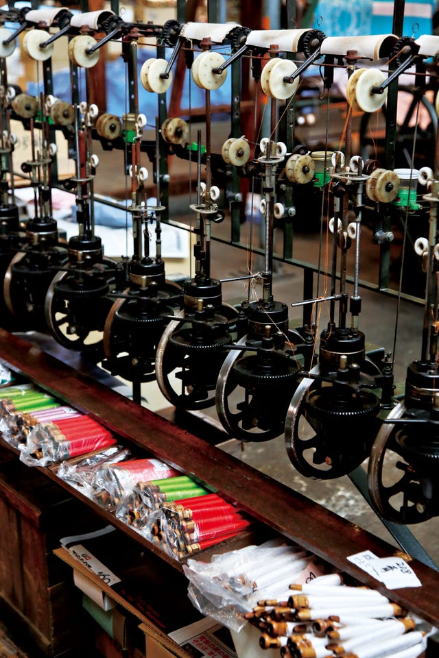industrial machinery with spools and colored rods