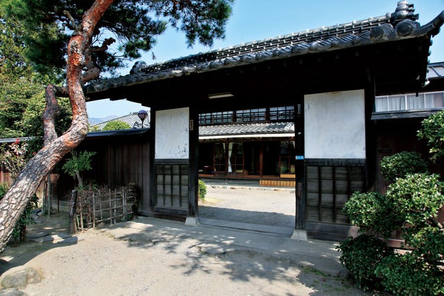 traditional japanese entrance gate leading to a courtyard