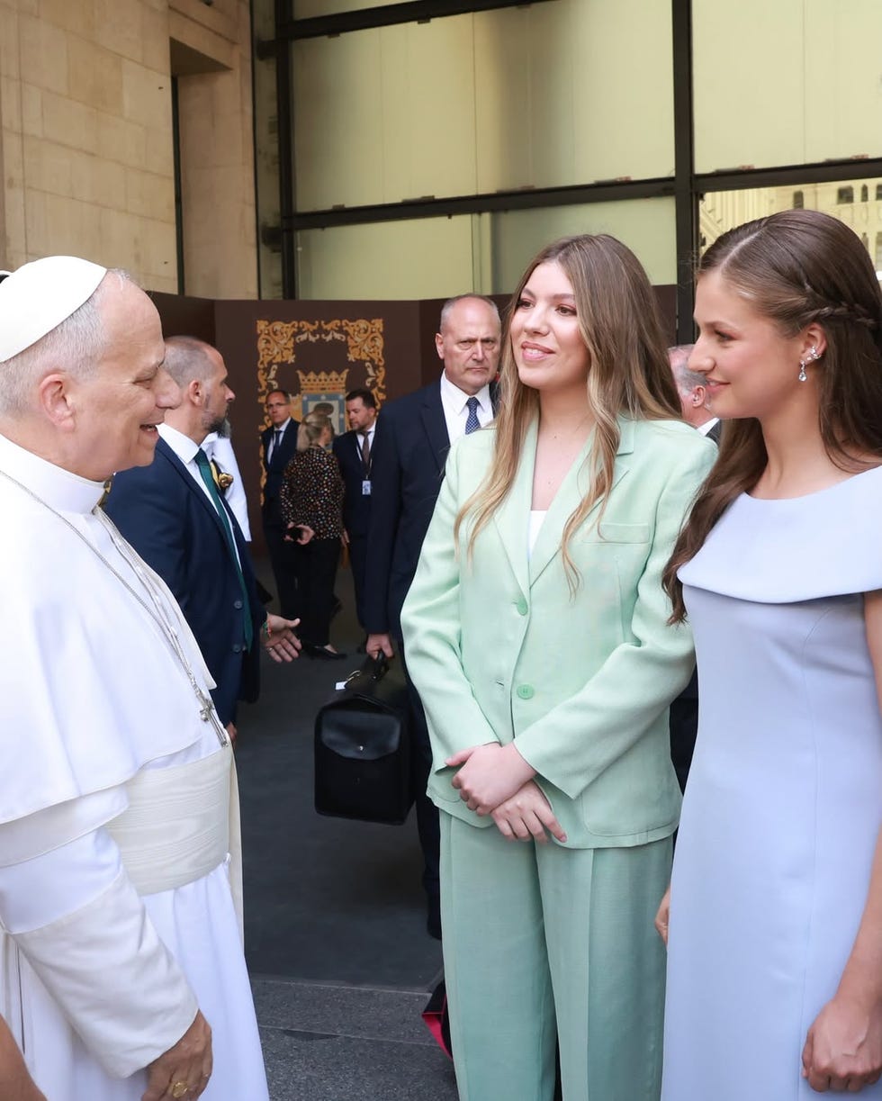 pope conversing with two women at an event pope conversing with two women at an event