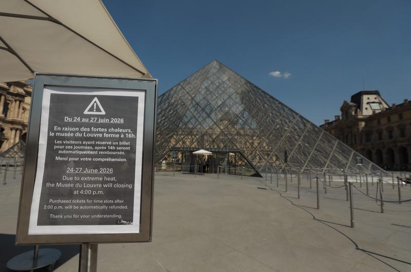 The Louvre Museum with a sign closing early in a heat wave.