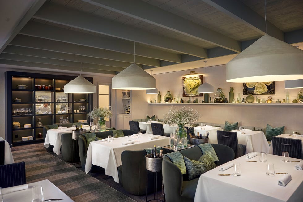 elegant restaurant interior with modern decor and white tablecloths. elegant restaurant interior with modern decor and white tablecloths.